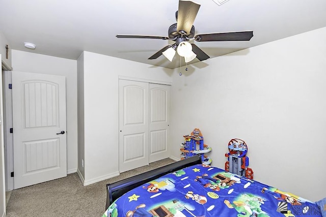 carpeted bedroom featuring ceiling fan and a closet