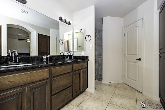 bathroom featuring tile patterned floors, ceiling fan, vanity, and a shower