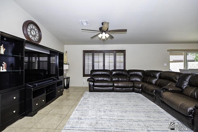 tiled living room with ceiling fan