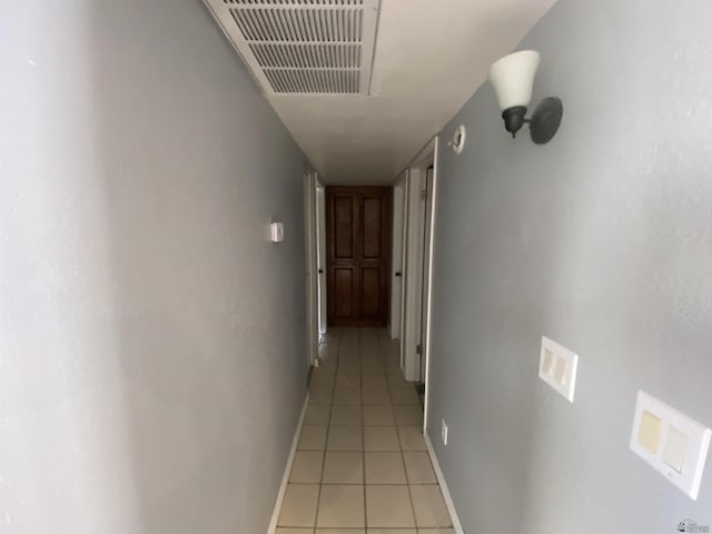 hall with light tile patterned floors