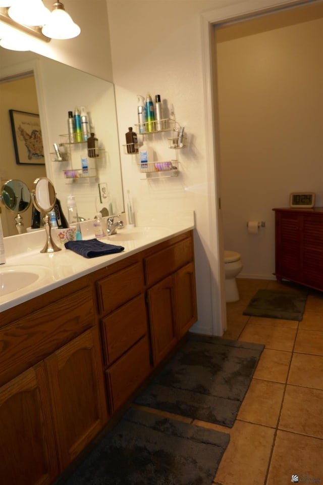 bathroom with tile patterned floors, vanity, and toilet