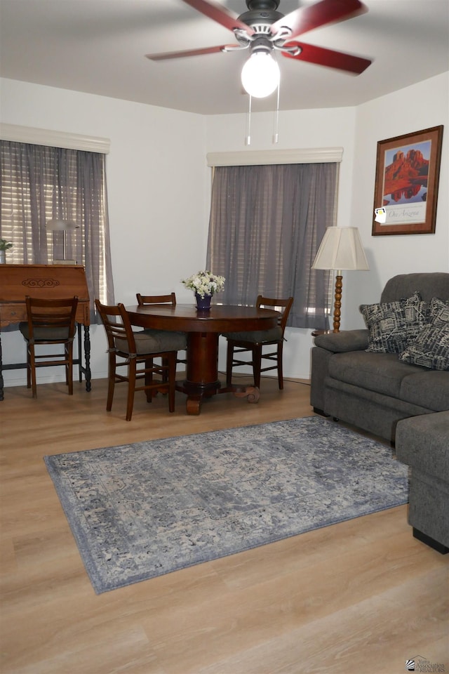 living room featuring hardwood / wood-style floors and ceiling fan