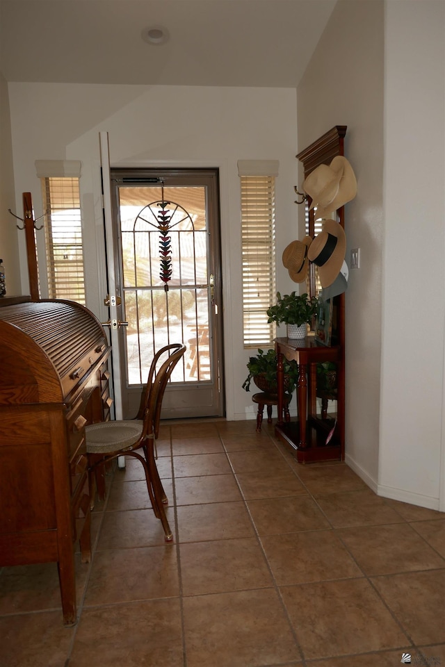 doorway to outside with tile patterned flooring