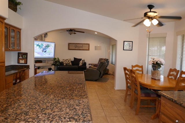 dining room featuring vaulted ceiling, ceiling fan, and light tile patterned flooring