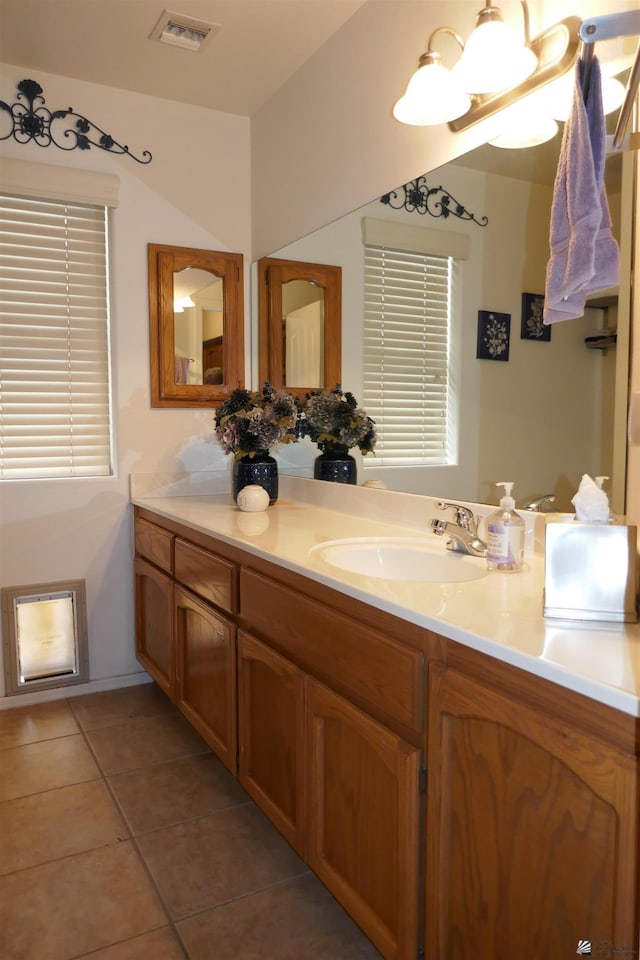 bathroom featuring tile patterned flooring and vanity