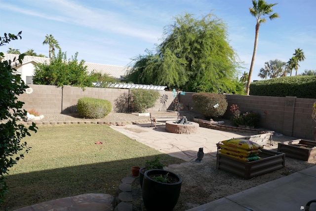 view of yard with a fire pit and a patio area