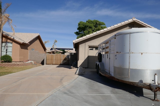 view of side of home featuring a garage