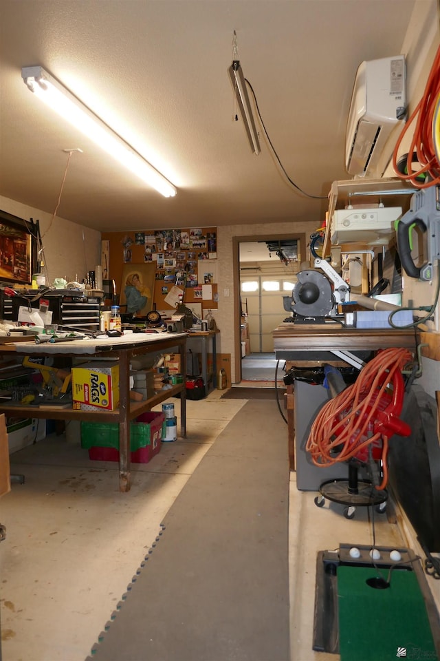 garage featuring a workshop area and a wall unit AC