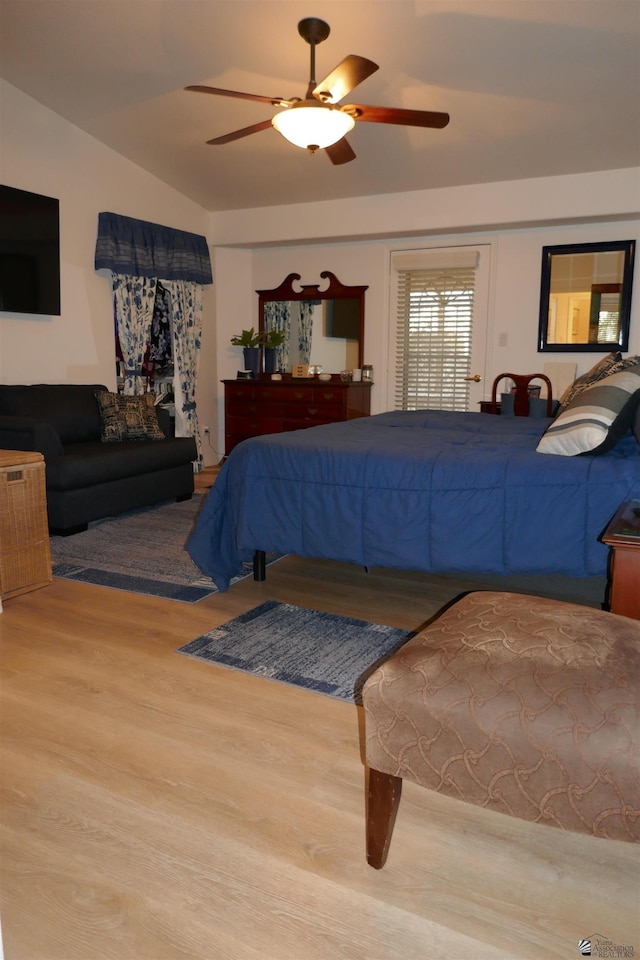 bedroom featuring hardwood / wood-style floors, ceiling fan, and lofted ceiling