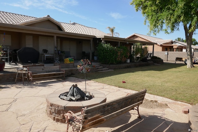 view of patio / terrace featuring area for grilling and a fire pit