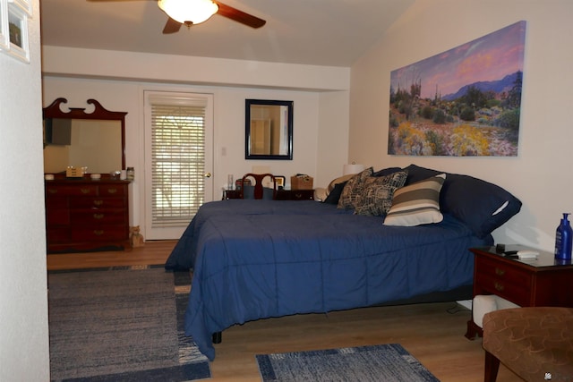 bedroom featuring hardwood / wood-style flooring, ceiling fan, and vaulted ceiling