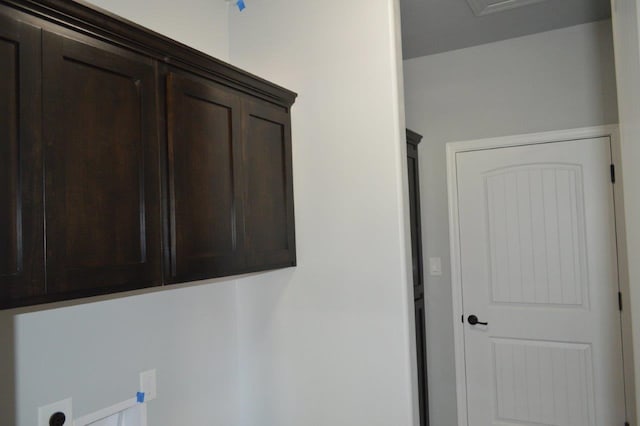 laundry area featuring electric dryer hookup and cabinets