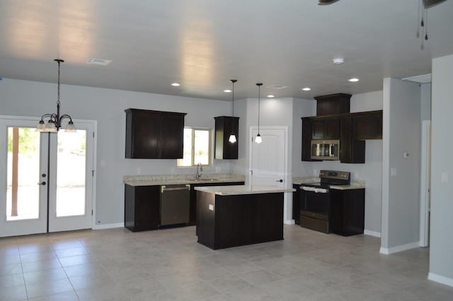 kitchen featuring french doors, decorative light fixtures, a notable chandelier, a kitchen island, and stainless steel appliances