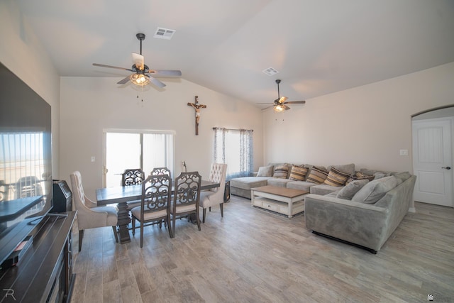 living room featuring light wood-type flooring, ceiling fan, and lofted ceiling