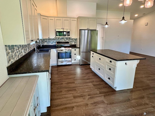 kitchen with white cabinetry, sink, a center island, and stainless steel appliances