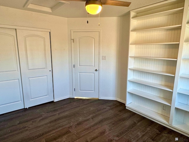 unfurnished bedroom featuring dark hardwood / wood-style floors, ceiling fan, and a closet