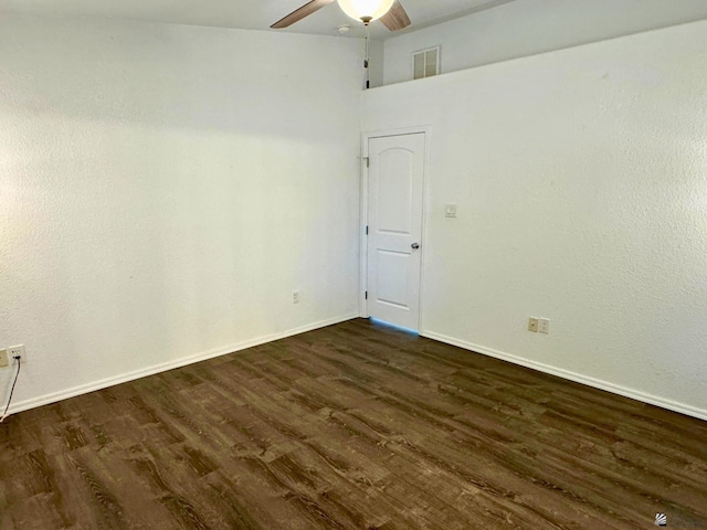 empty room featuring ceiling fan and dark wood-type flooring