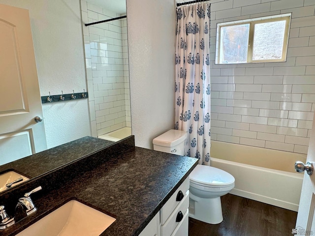 full bathroom featuring vanity, hardwood / wood-style flooring, toilet, and shower / bathtub combination with curtain