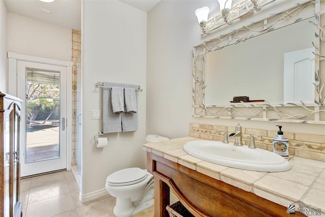 bathroom featuring tile patterned floors, vanity, and toilet