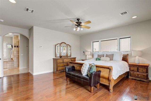 bedroom featuring hardwood / wood-style flooring, ceiling fan, and ensuite bathroom