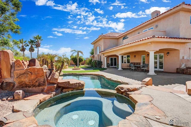 view of pool with an in ground hot tub, french doors, and a patio