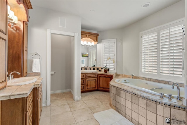 bathroom with tile patterned flooring, vanity, and a relaxing tiled tub