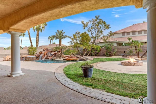 view of yard featuring a patio and an outdoor fire pit