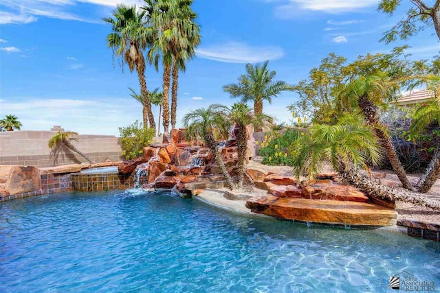 view of swimming pool with pool water feature