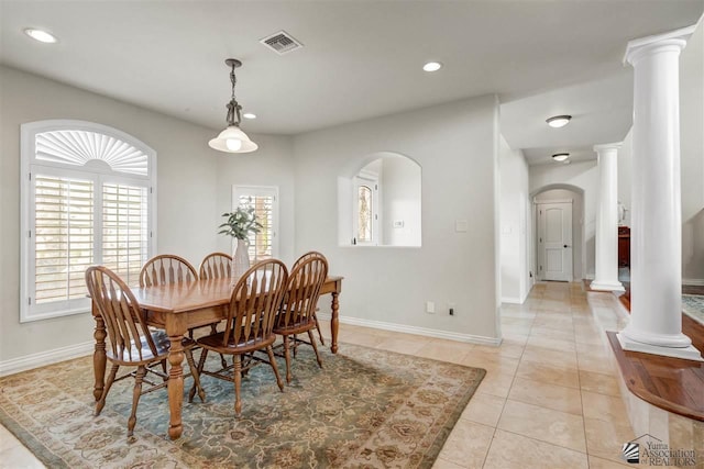 dining area with light tile patterned floors and ornate columns