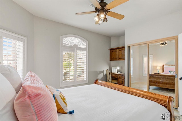 bedroom featuring ceiling fan, a closet, and multiple windows