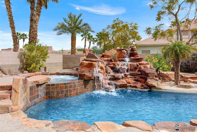 view of swimming pool with an in ground hot tub and pool water feature