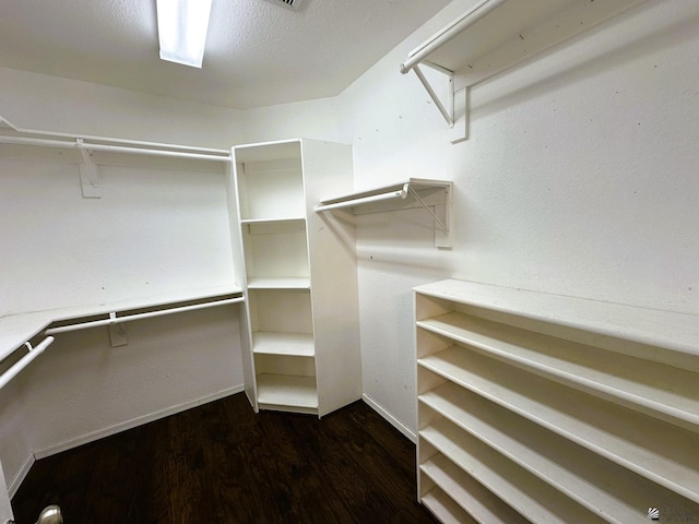 walk in closet featuring dark hardwood / wood-style flooring