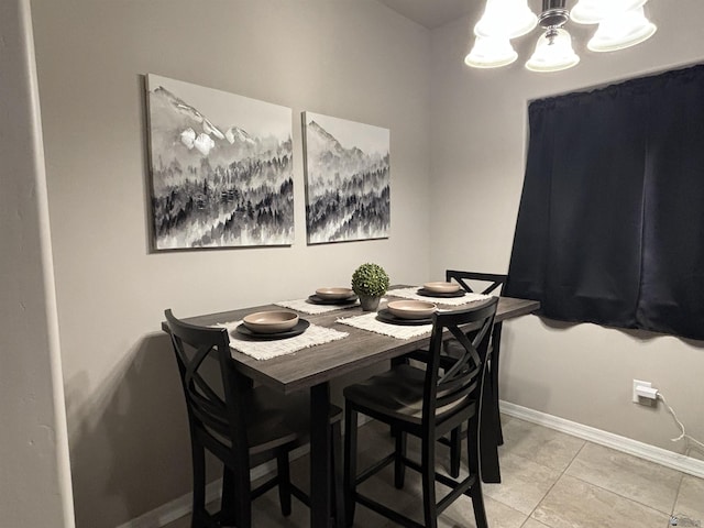 dining room with tile patterned floors and a chandelier