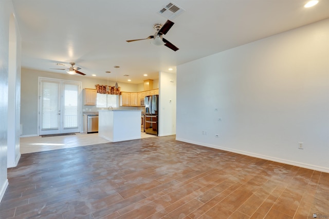 unfurnished living room with ceiling fan and light wood-type flooring