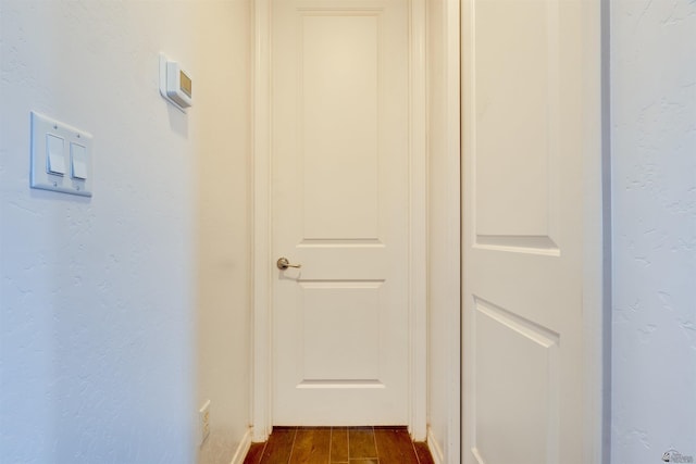 corridor featuring dark wood-type flooring