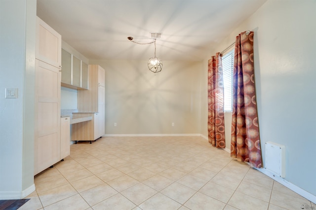 interior space featuring light tile patterned flooring and a chandelier