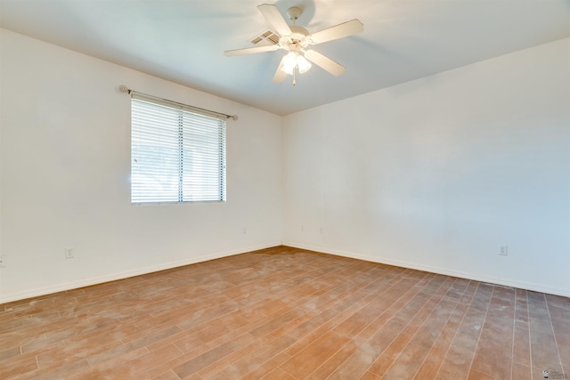 empty room featuring ceiling fan and light hardwood / wood-style flooring