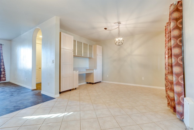 interior space featuring radiator heating unit and an inviting chandelier