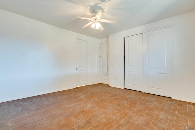 unfurnished bedroom with ceiling fan and light wood-type flooring