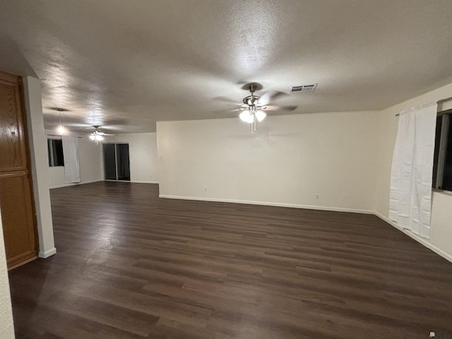 unfurnished living room featuring dark hardwood / wood-style floors and a textured ceiling