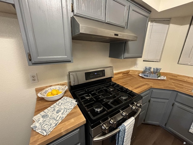 kitchen with wooden counters, gray cabinets, and stainless steel range with gas cooktop