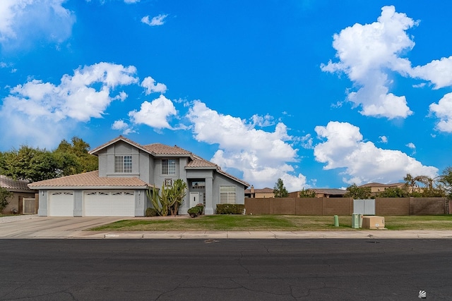 view of front of property featuring a garage and a front yard