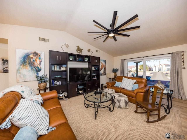 living room with light hardwood / wood-style flooring, ceiling fan, and lofted ceiling