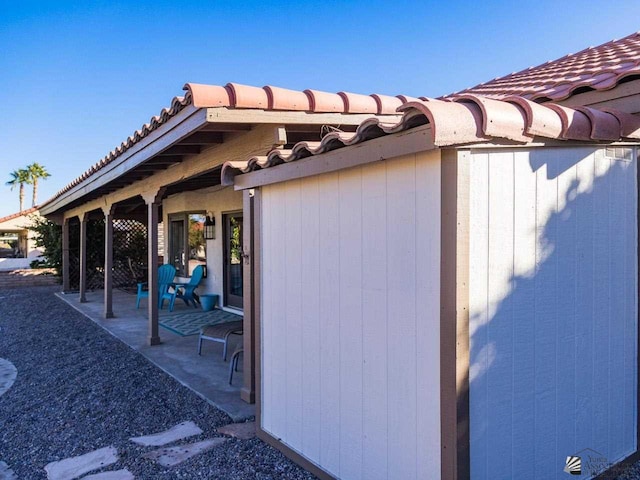 view of property exterior with a patio area