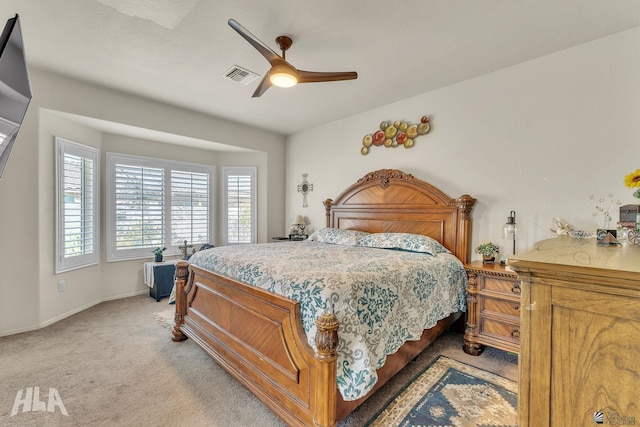 bedroom with light carpet, baseboards, visible vents, and a ceiling fan