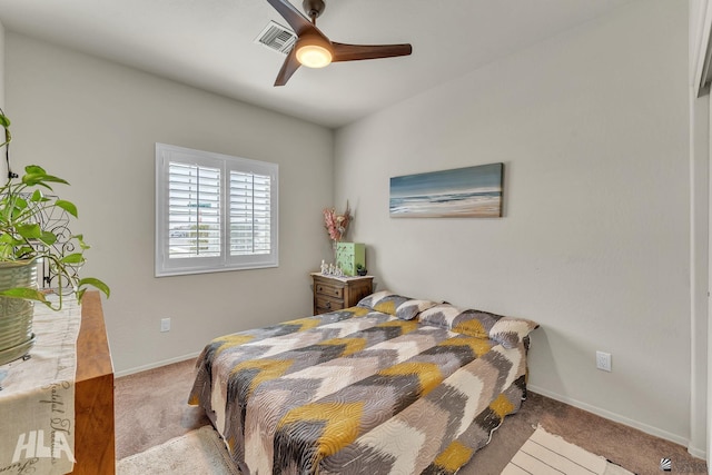 bedroom with light carpet, ceiling fan, visible vents, and baseboards