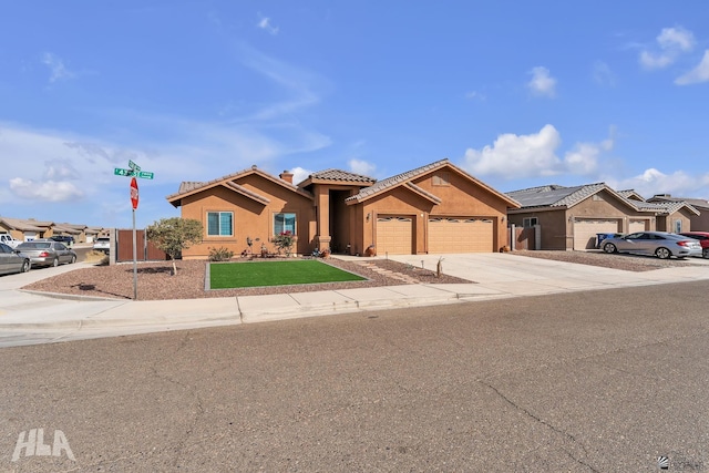 view of front of property featuring stucco siding, an attached garage, a residential view, driveway, and a tiled roof