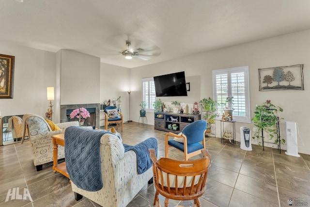 tiled living room featuring ceiling fan and a multi sided fireplace