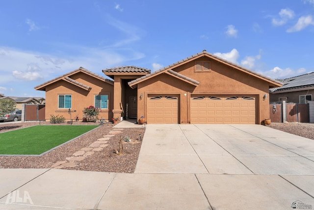 view of front of property with driveway, a tiled roof, an attached garage, a front lawn, and stucco siding