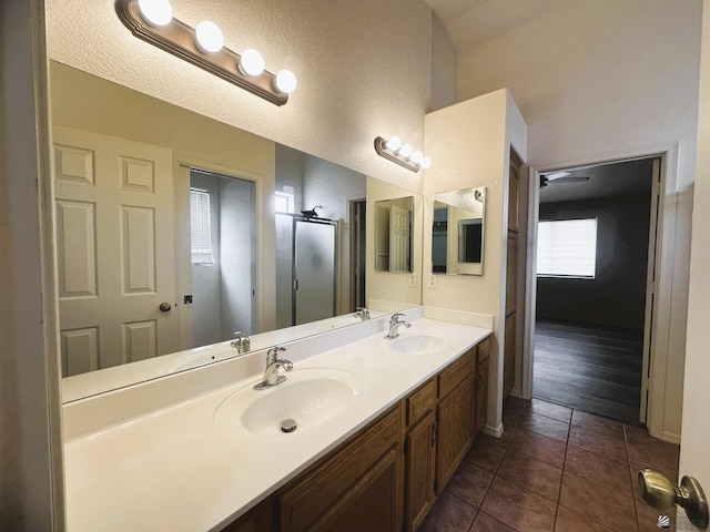 bathroom with double vanity, tile patterned flooring, and a sink